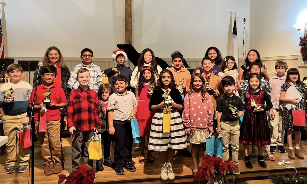 Bright Keys Piano Studio students celebrating at their recital with trophies